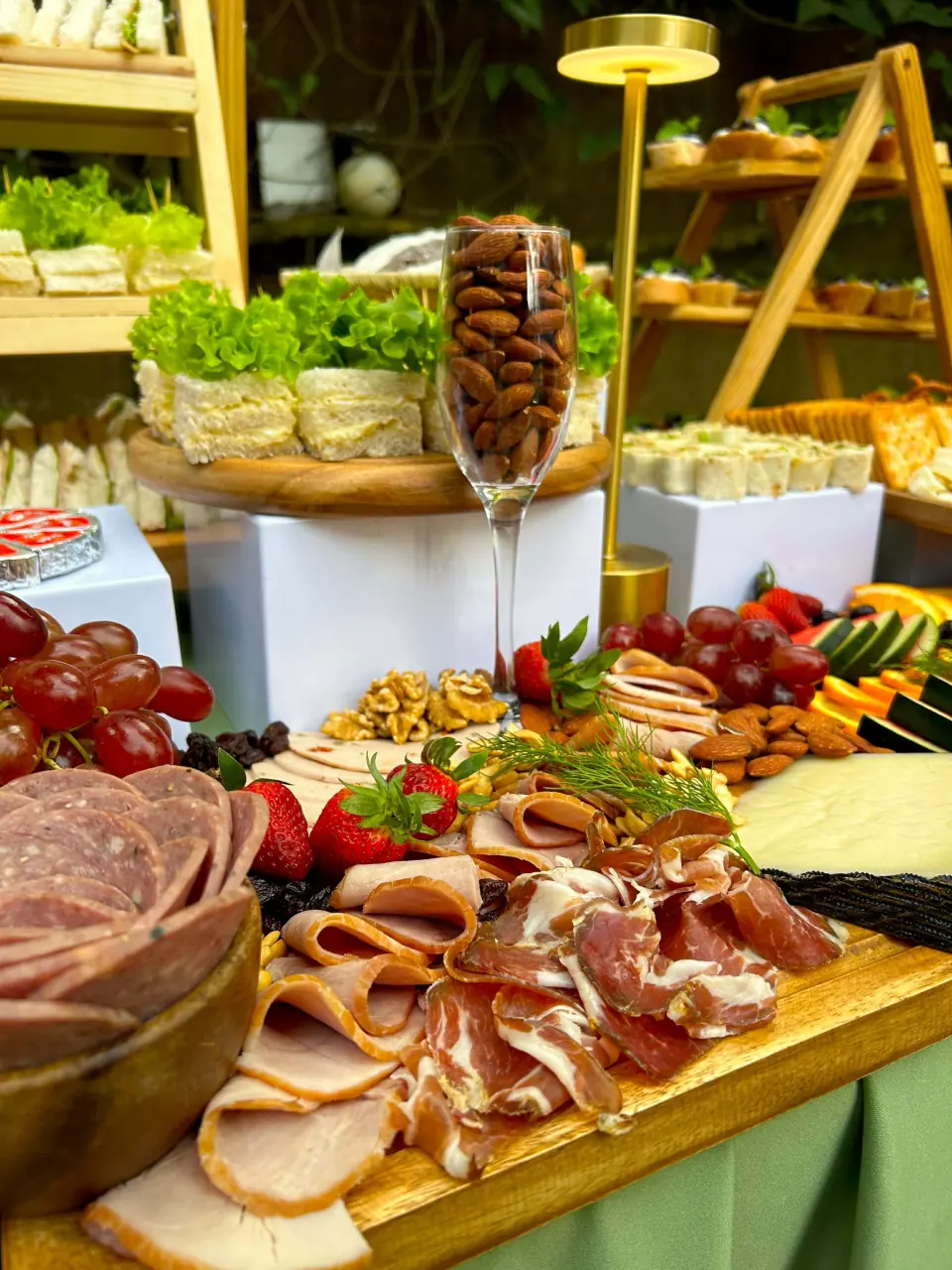 Charcuterie board with cold cuts, fruit, and accompaniments