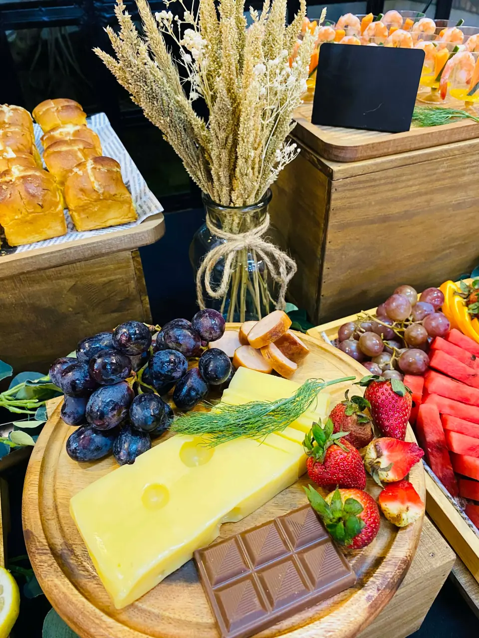 Grazing board with cheese, fresh fruit, and chocolate