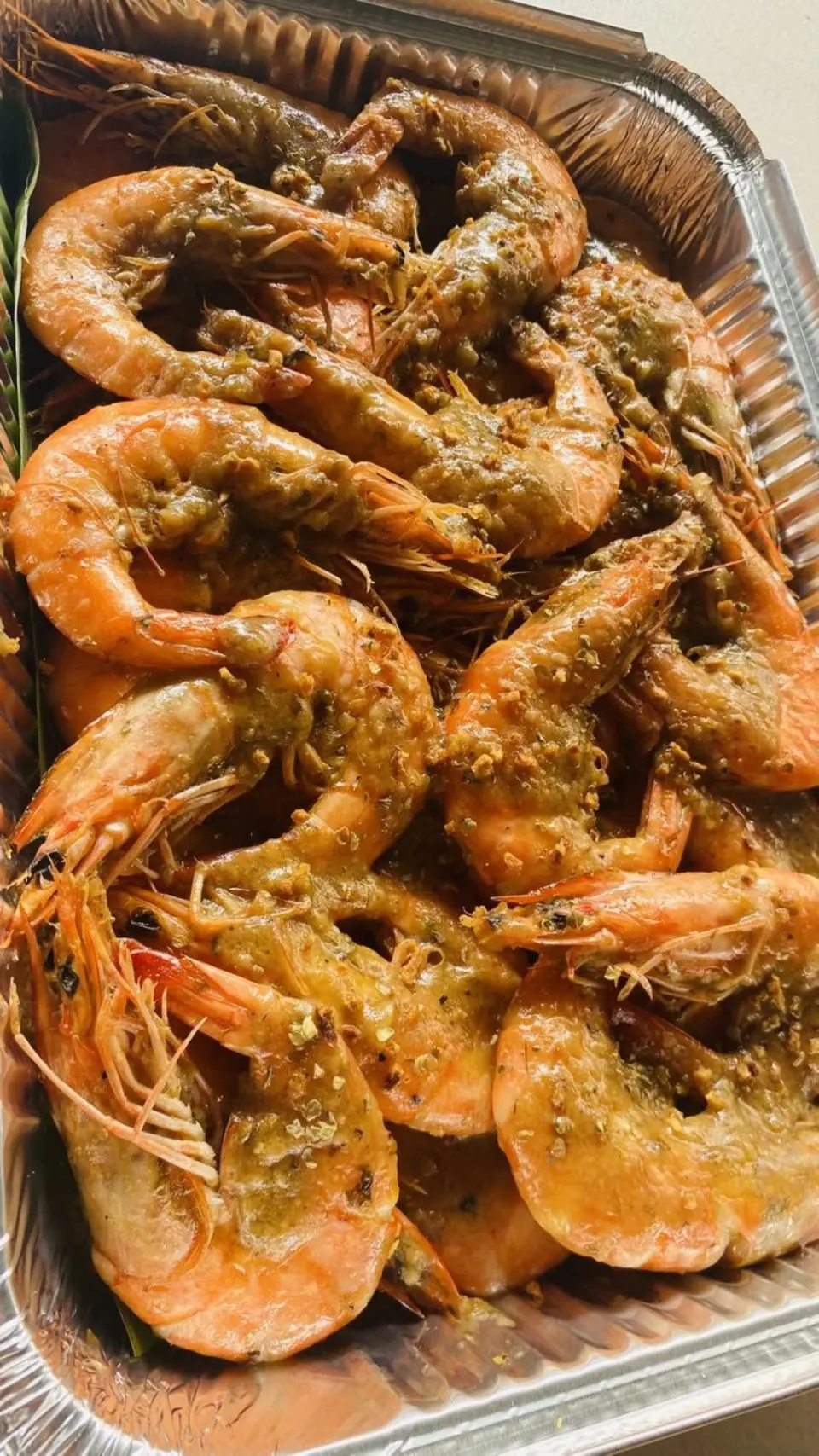 Party tray filled with large shrimp cooked in a rich garlic butter sauce