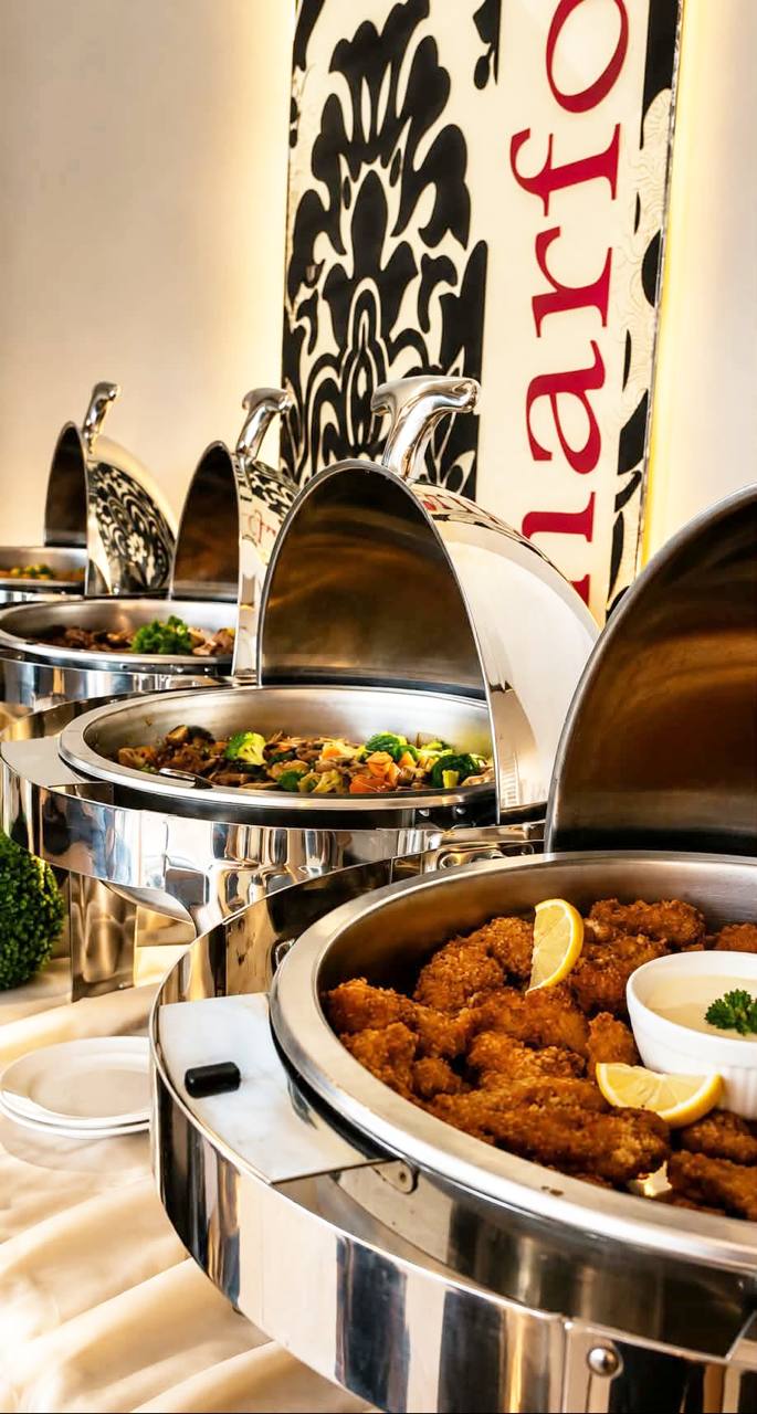 Buffet dishes presented in polished chafing dishes